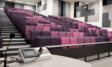 Inside of University lecture theatre showing the purple seats 