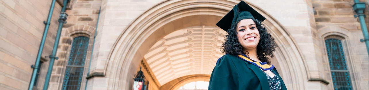 Student graduating outside University arch