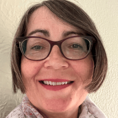 Woman with short brown hair and glasses