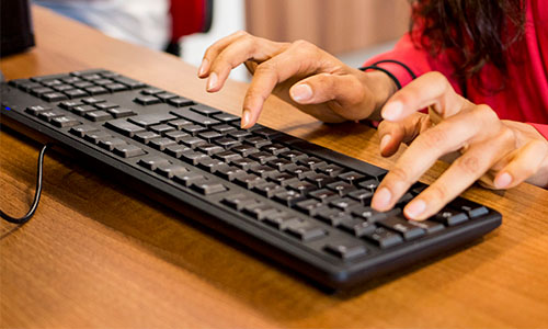 Hands typing on keyboard