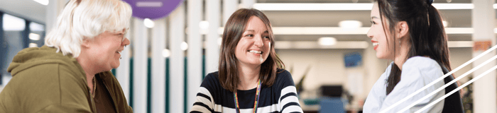 Photo of staff smiling at a student 