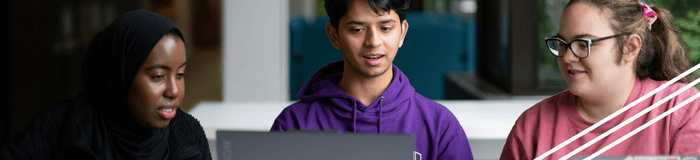 Students huddled around their laptops