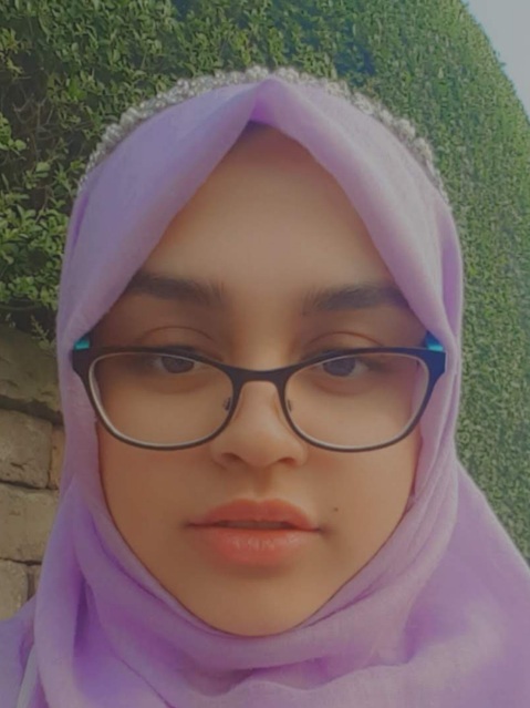 This is a photo of Masnuna wearing a lilac headscarf and wearing glasses.