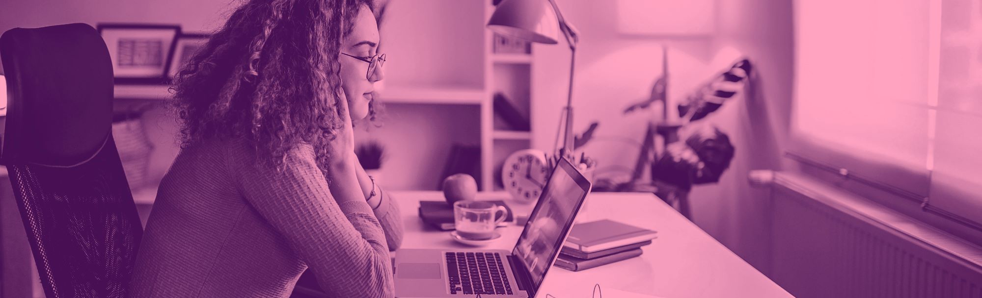 young woman sitting working at laptop