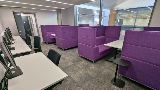 Image of commuter space with purple booths