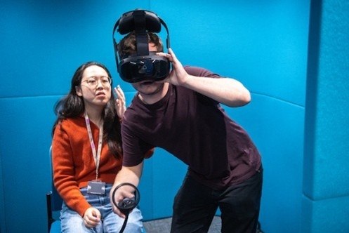 Image of a teacher and a student using a virtual reality headset