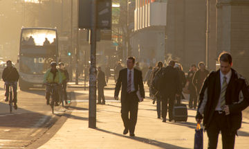 Man walking through congested city street 