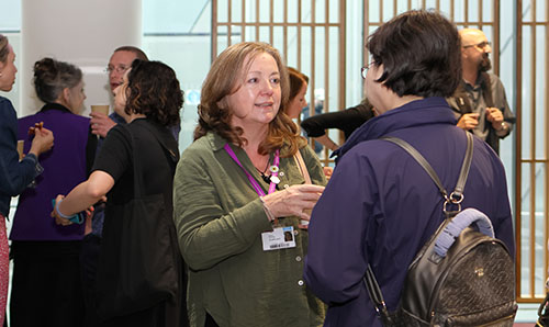 Two delegates talking and smiling