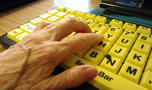 Person using large type accessible keyboard