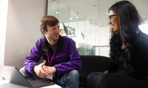 Two members of staff talking