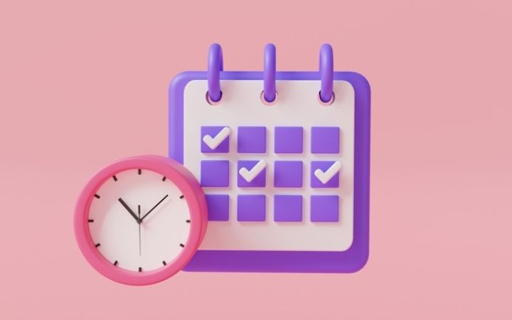 clock and calendar on pink background