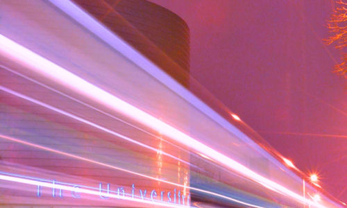 Image of University Place lit up at night 