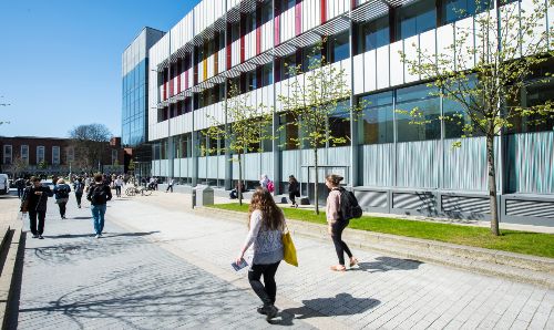 People walking by the library.