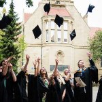 Image of graduates throwing caps up