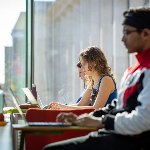People sat at desks on laptops