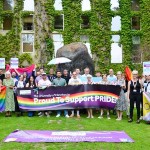 Colleagues holding pride flags