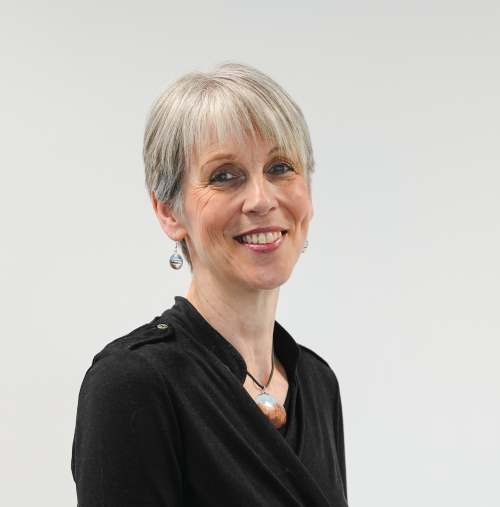 Image of Jackie Reynolds. Two thirds portrait of smart woman with short grey hair in a black top