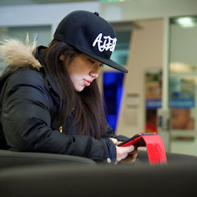 Young Asian woman sat at her laptop working 