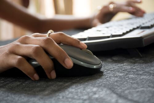 woman hand clicking mouse close up