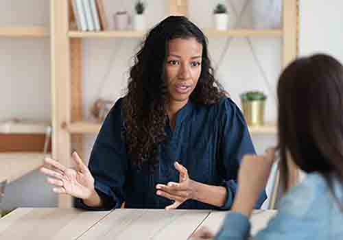 Women-talking-to-someone-in-the-foreground