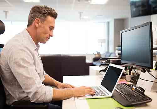 Man at an IT desk typing