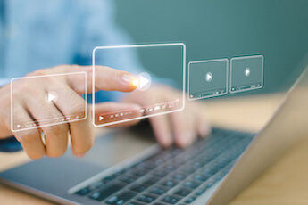 A computer generated image of a woman touching a video to make it play