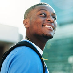 Happy man glancing upwards, smiling. 