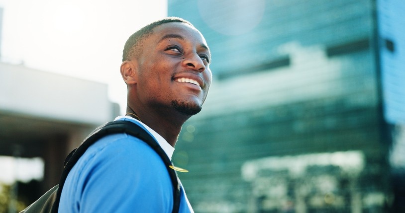 Happy man glancing upwards, smiling. 