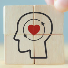 Four tiles combined to create an icon image of a head with a heart inside with two arrows circling around it.
