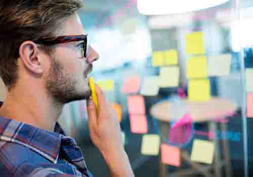 Man stood at a planning wall of posits