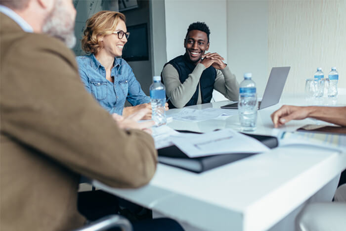Team members in a meeting communicating happily