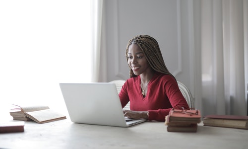 woman-in-red-long-sleeve-shirt-using-macbook