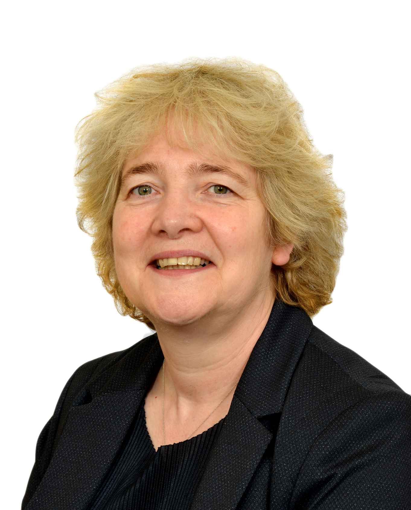 Photograph of Professor Caroline Bowsher smiling in front of a white backdrop