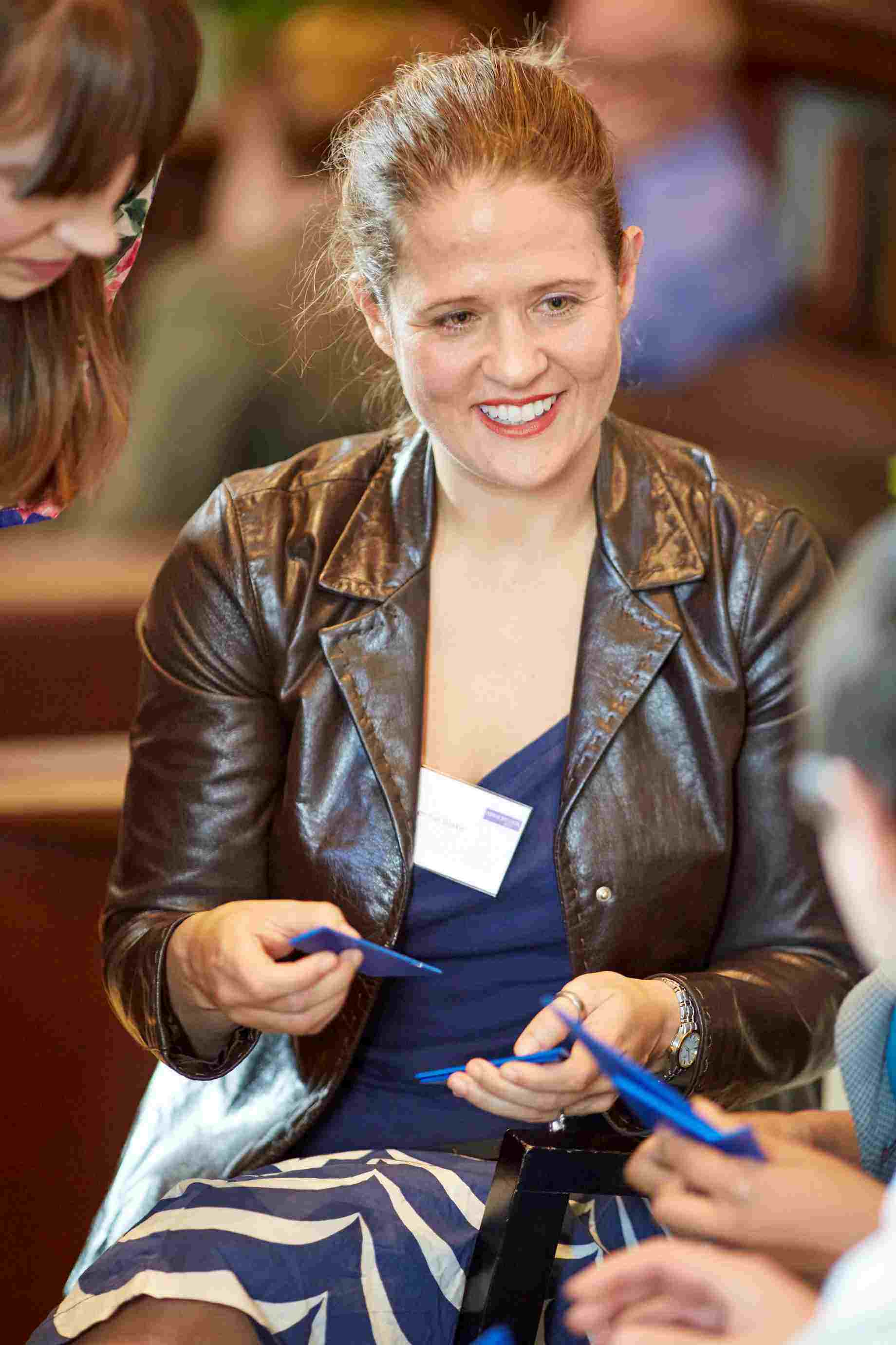 Photograph of Jennie Blake smiling in conversation with someone else