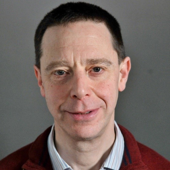 Image of Professor Peter Kahn smiling in front of a grey backdrop
