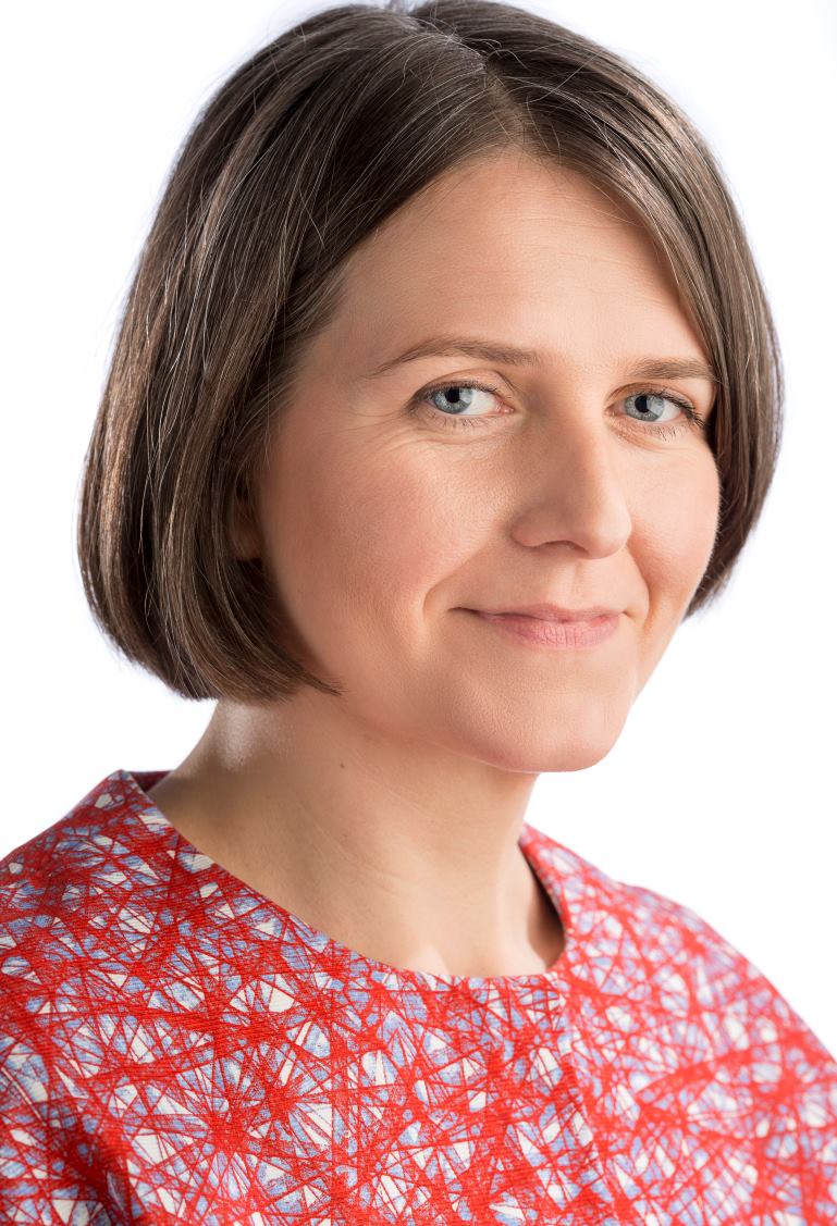 Photograph of Sarah Dyer smiling against a pale background