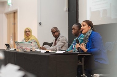 A close up image of the four main speakers at the first plenary session of the conference.