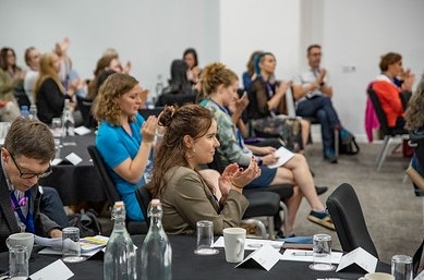 An image of the audience clapping after the final plenary talks.