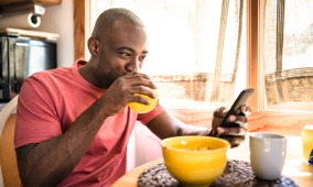 Man checking mobile at breakfast